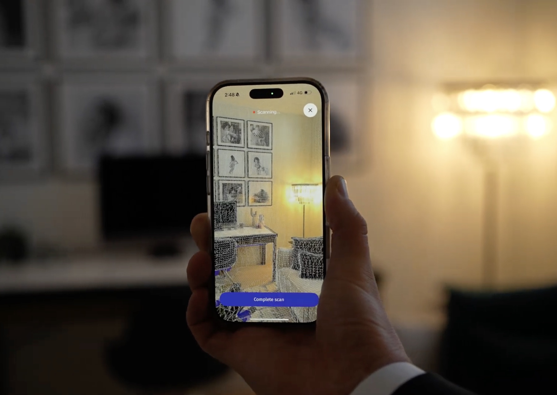 The Roomio scan screen mid capture, a LiDAR mesh forming over a living room
